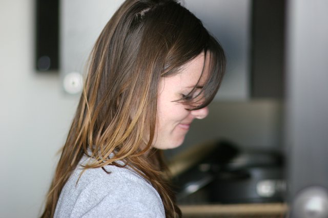 Windswept Hair Cascading Over a Smiling Face