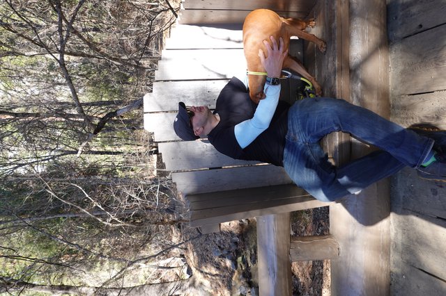 Man and Dog Resting on Park Bench