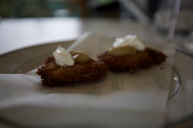 Crispy Fried Delicacy with Cream Garnish at Ashes and Diamonds