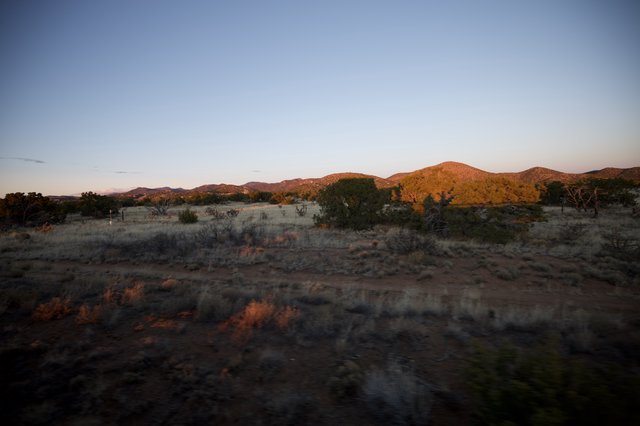 Desert Twilight Over Scrubland Hills and Mountains