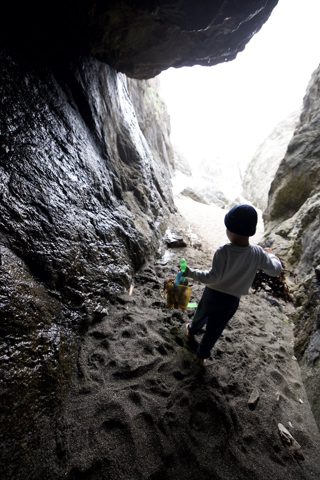 Young Explorer Ventures Through Sea Cave Passage