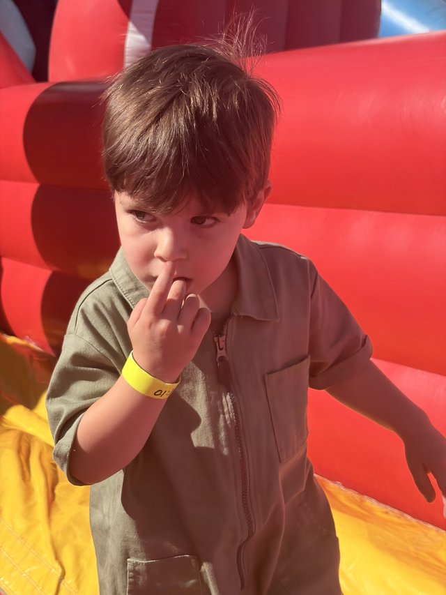 Young Boy Making Shh Gesture at Indoor Play Center