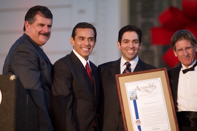 Four Men in Suits Receiving a Certificate