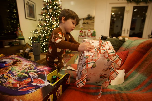 Child Unwrapping Christmas Presents on Christmas Morning