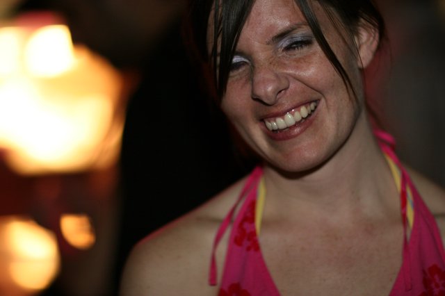 Laughing Woman in Pink at a Nighttime Gathering