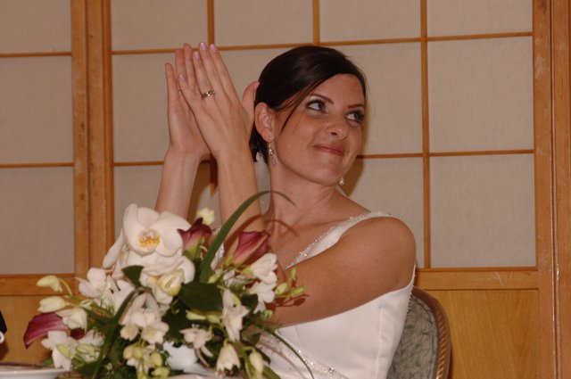 Bride Clapping Joyfully at Wedding Reception