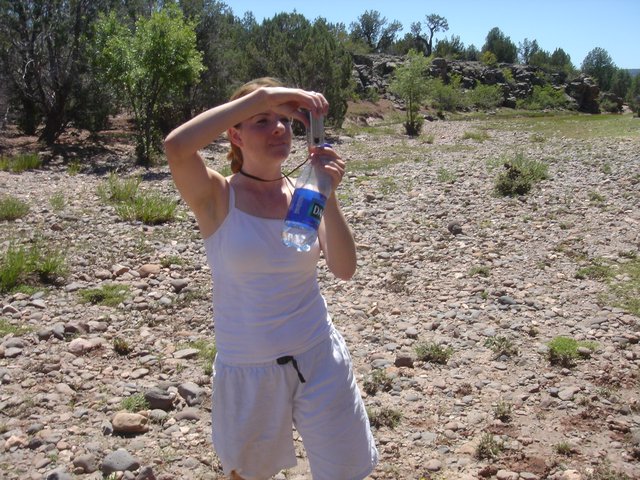 Woman Takes Photo in Arid Rocky Desert Landscape