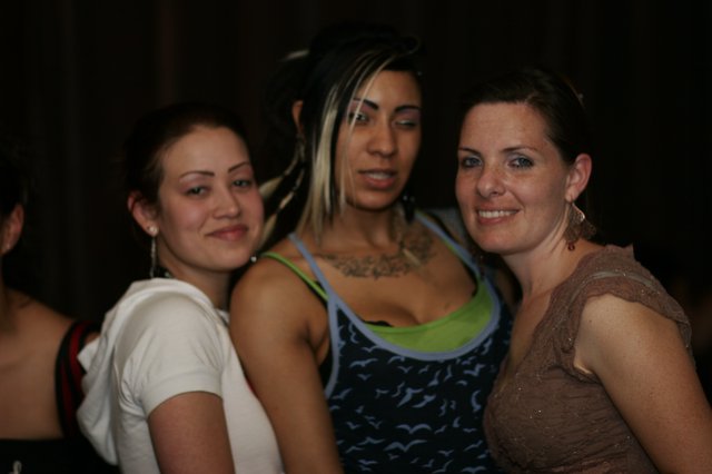 Three Friends Celebrating at a Nightclub Event