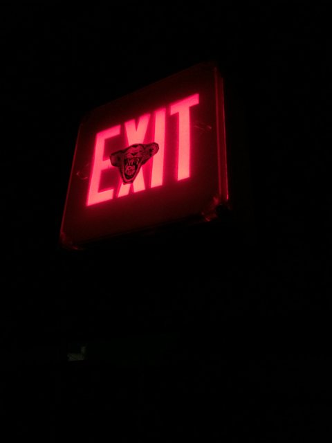 Bright Red Exit Sign in the Dark