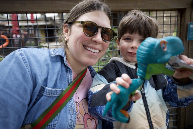 Mother and Son's Joyful Day with Dinosaur Toy