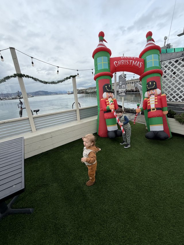 Children Playing by Christmas Inflatable Display at Waterfront