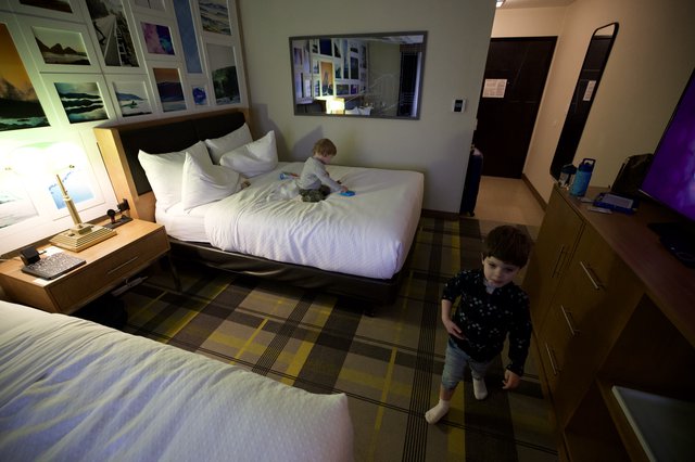 Two Young Children Playing in Modern Hotel Room