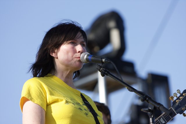 A Yellow Shirted Kelley Deal Plays the Acoustic Guitar