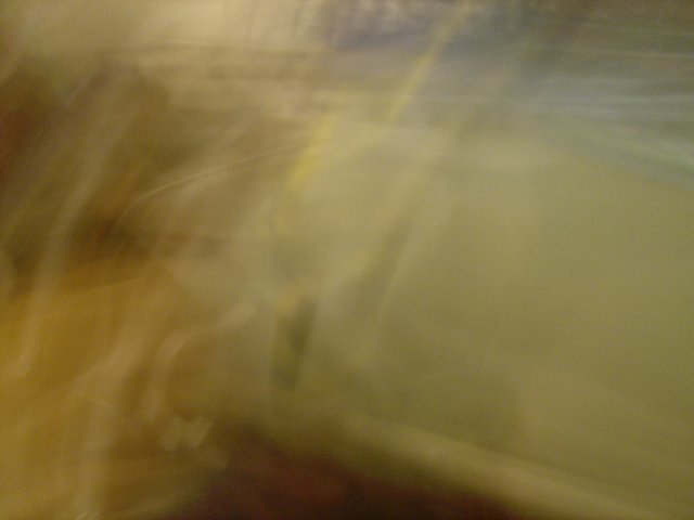Blurry figure in wooden surroundings