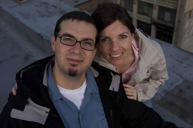 Dave and Penelope Smiling Atop Urban Rooftop