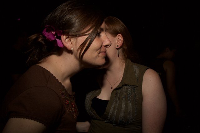 Two Women Share an Intimate Moment at Night Event