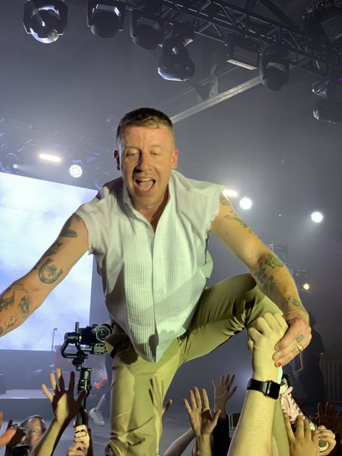 Macklemore Rocks the Stage with Tattoos and Style