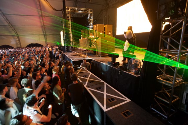 Green Laser Lights Illuminate Excited Crowd at Coachella Concert