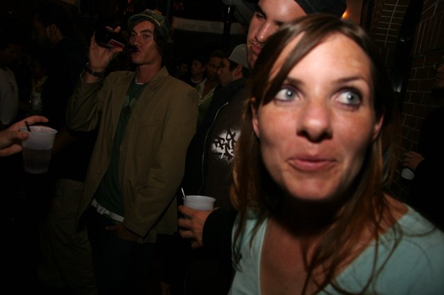 Wide-Eyed Woman at a Crowded Nightclub Party
