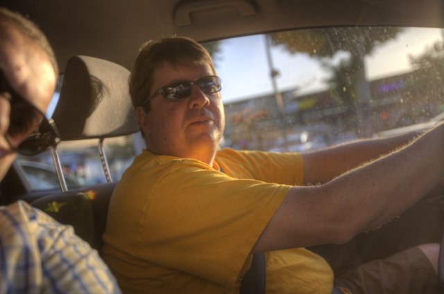 Golden Hour Drive: Passenger Glances Back at Camera