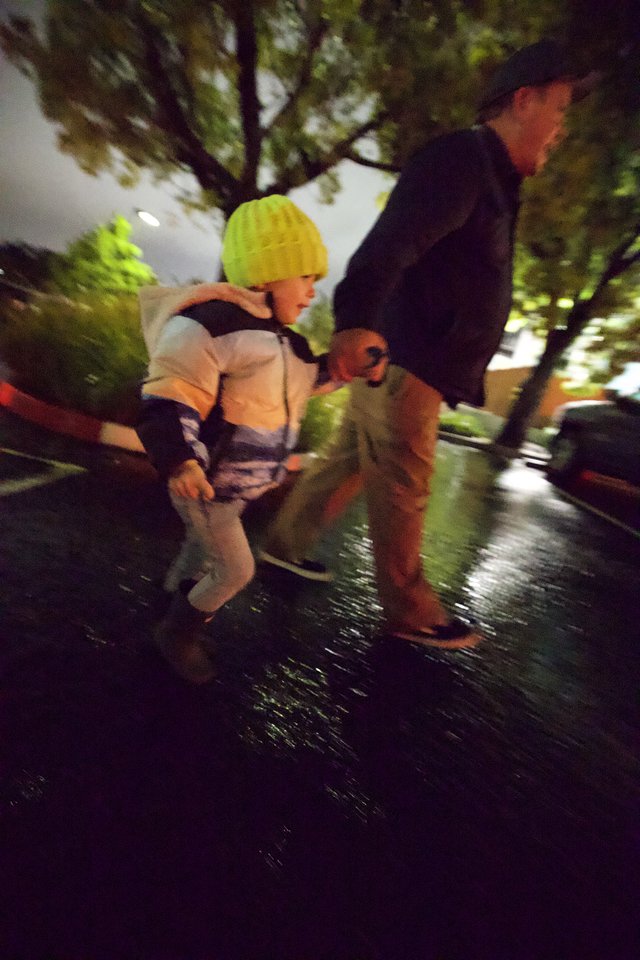 Night Rescue: Emergency Personnel Assisting Child in Yellow Hat