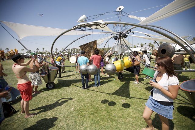 A Group Gathering Around A Metal Structure at Coachella