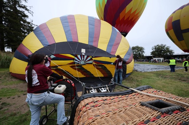 Ground Crew Inflating Hot Air Balloons at Festival