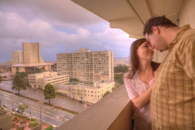 Romantic Balcony Moment Overlooking a City at Dusk