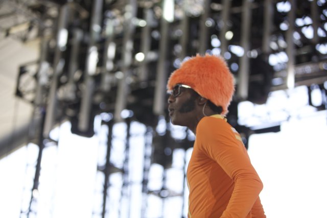 Man on Stage in Orange Hat and Beanie