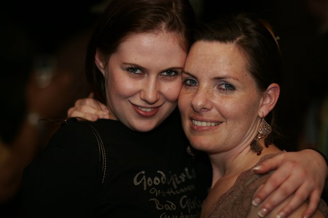 Two Friends Embrace at a Late Night Celebration