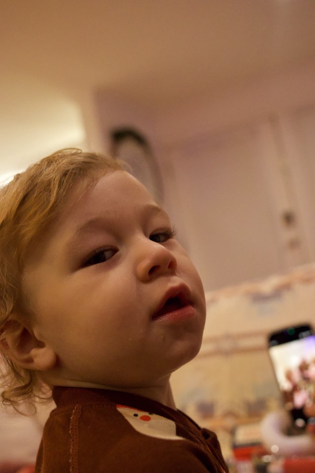 Curious Toddler Looking Up During Christmas Celebration