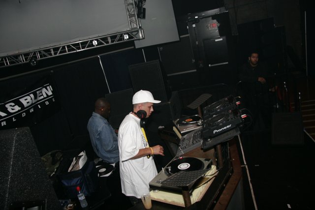 Dj S Playing a Set in a White Hat