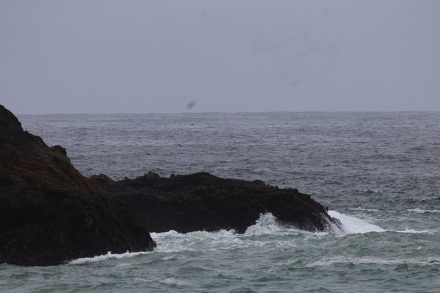 Rough Seas Breaking Against Dark Coastal Rocks