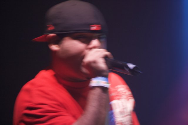 Red Shirted Entertainer with Microphone and Baseball Cap