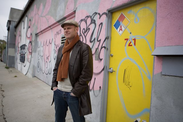 Junkie XL poses in front of urban art