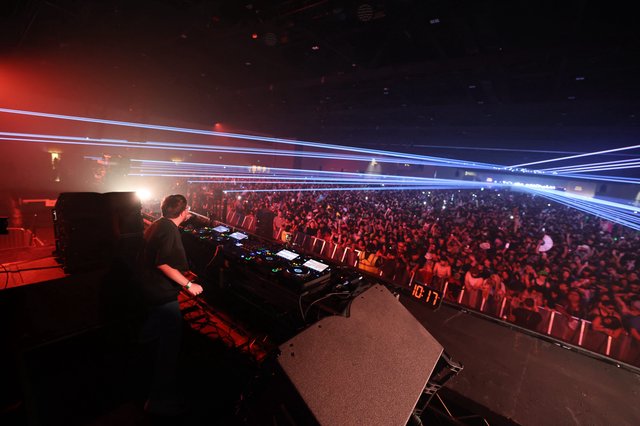 DJ Ignites Massive Crowd with Laser Light Show