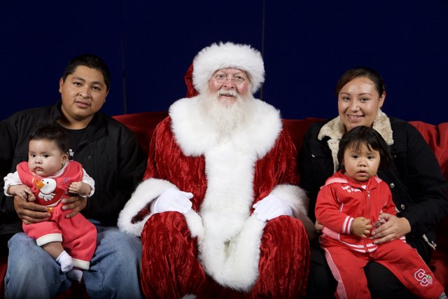 Christmas Cheer: Smiling Family Poses with Santa Claus
