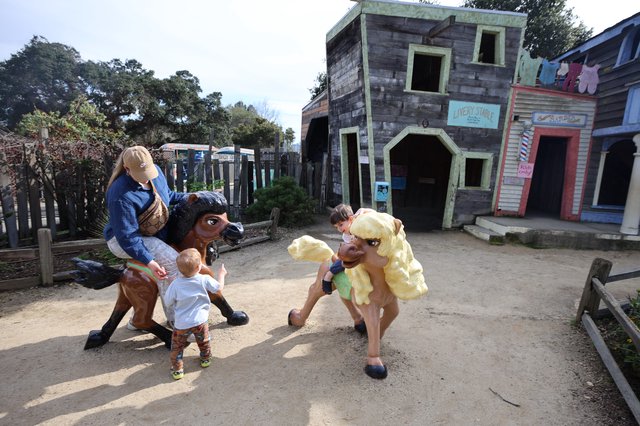 Children Playing with Costumed Characters in Western Town Set
