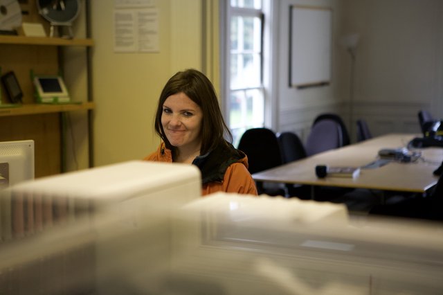 Woman Smiling Behind Office Desk in 2008
