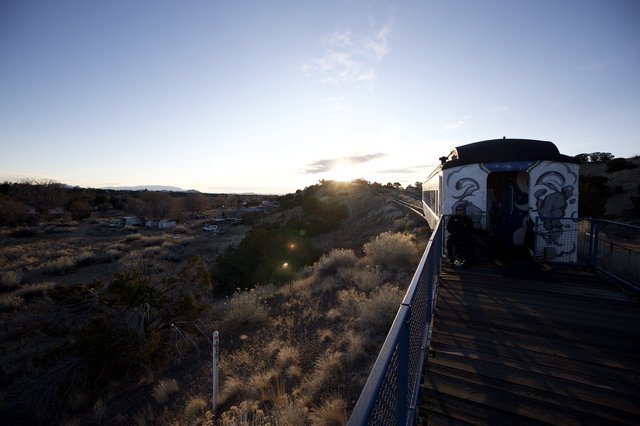 Sunset Train Journey Through Desert Landscape