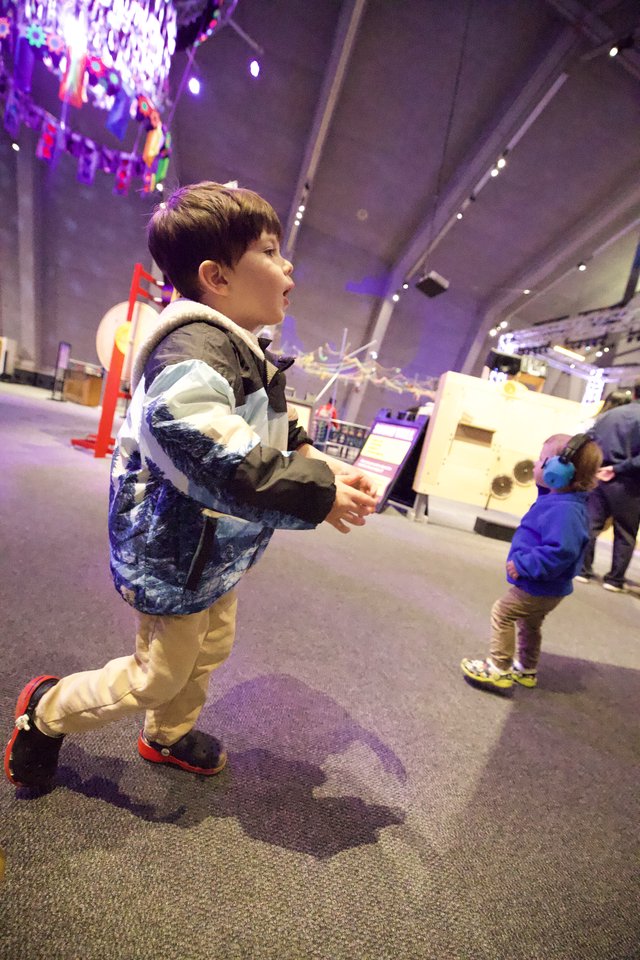 Young Boy Explores Interactive Science Museum Exhibit