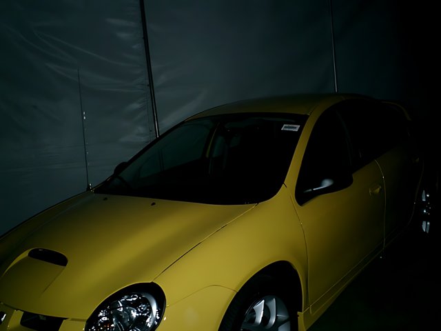 Bright Yellow Sports Car in Dark Arena