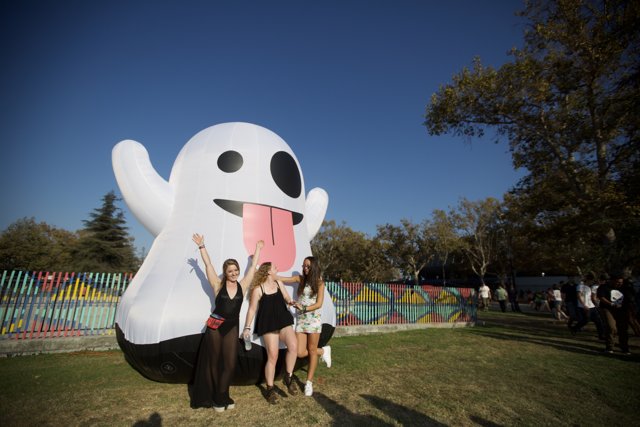 Giant Inflatable Ghost Poses with Three Women