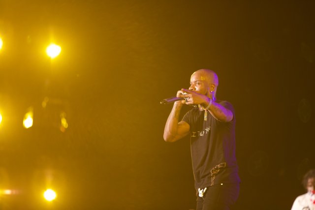 Tory Lanez Lights Up Coachella Stage Caption: Singer and performer Tory Lanez electrifies the crowd with his brass section and powerful vocals as he holds a microphone at Coachella 2017.