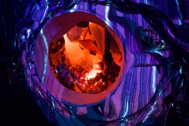 Inside the Cosmic Portal: Orange-Lit Installation View