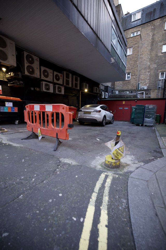 Urban Alley Construction Site with White SUV