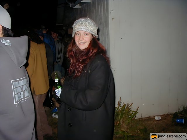 Red-Headed Woman Holding a Beer and Wearing a Beanie