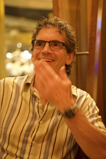 Smiling Man with Glasses and Striped Shirt