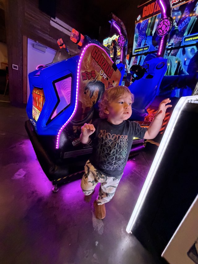 Young Gamer Immersed in Arcade Action