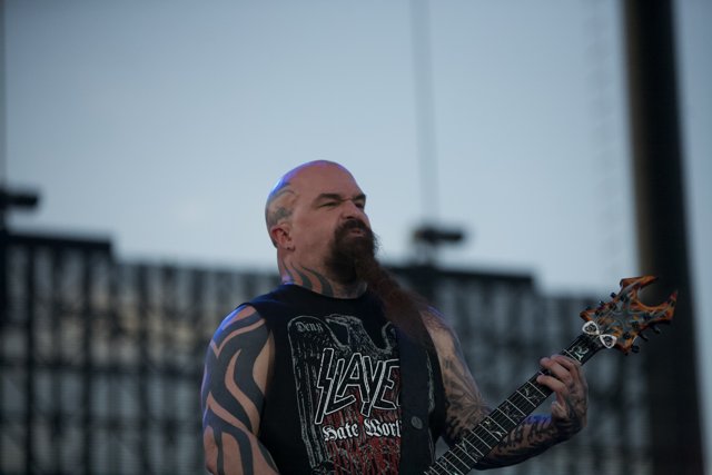 Kerry King shreds on his electric guitar under the blue sky at the Big Four Festival
